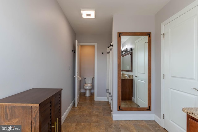 full bathroom featuring toilet, vanity, and baseboards