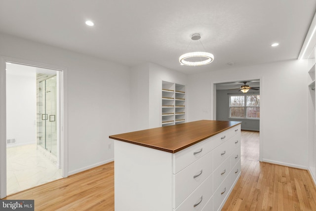 spacious closet with ceiling fan and light wood finished floors