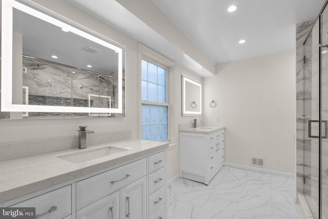 full bath with a marble finish shower, marble finish floor, a sink, and baseboards