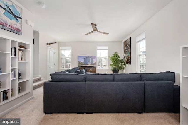 carpeted living room with a ceiling fan