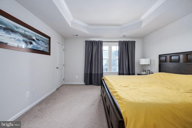 bedroom with a tray ceiling, crown molding, visible vents, carpet flooring, and baseboards