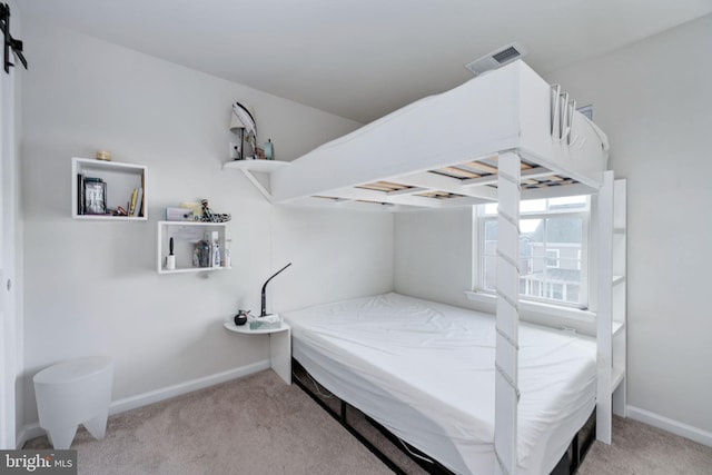 bedroom featuring visible vents, light carpet, and baseboards