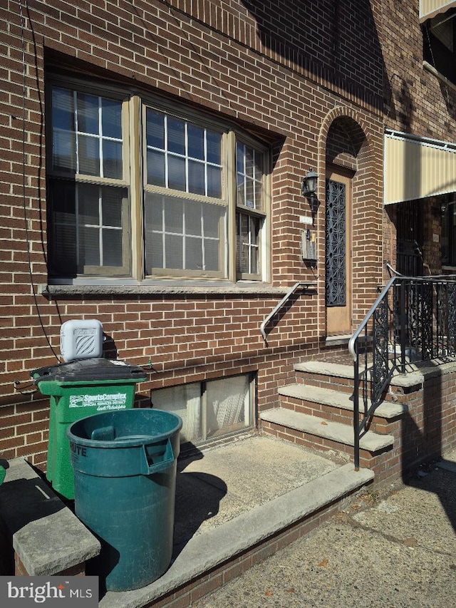 view of exterior entry with brick siding