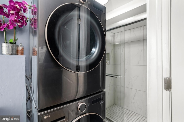 washroom with stacked washer / drying machine and laundry area