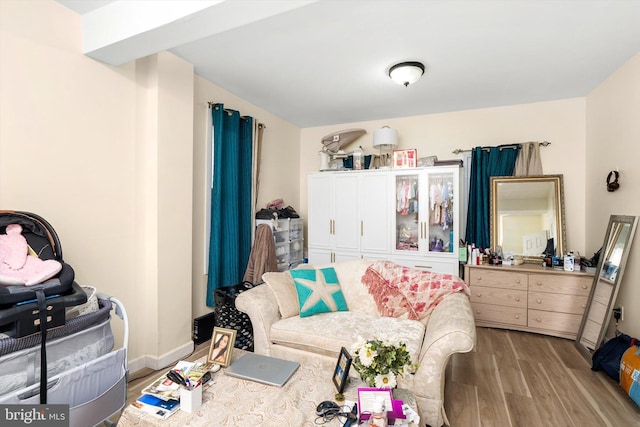 interior space featuring baseboards and wood finished floors