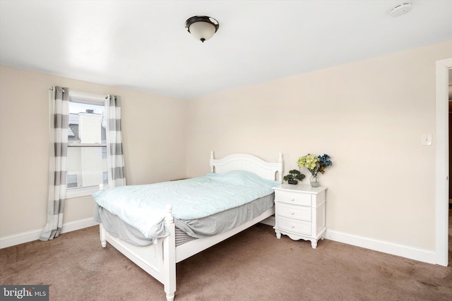 bedroom with light carpet and baseboards