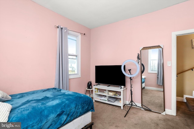 bedroom with carpet floors and baseboards