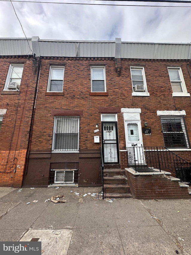 view of property featuring brick siding