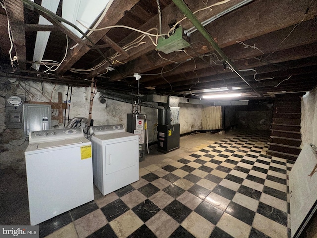 unfinished below grade area with heating unit, water heater, separate washer and dryer, and tile patterned floors