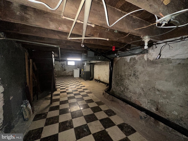 basement featuring heating unit and tile patterned floors