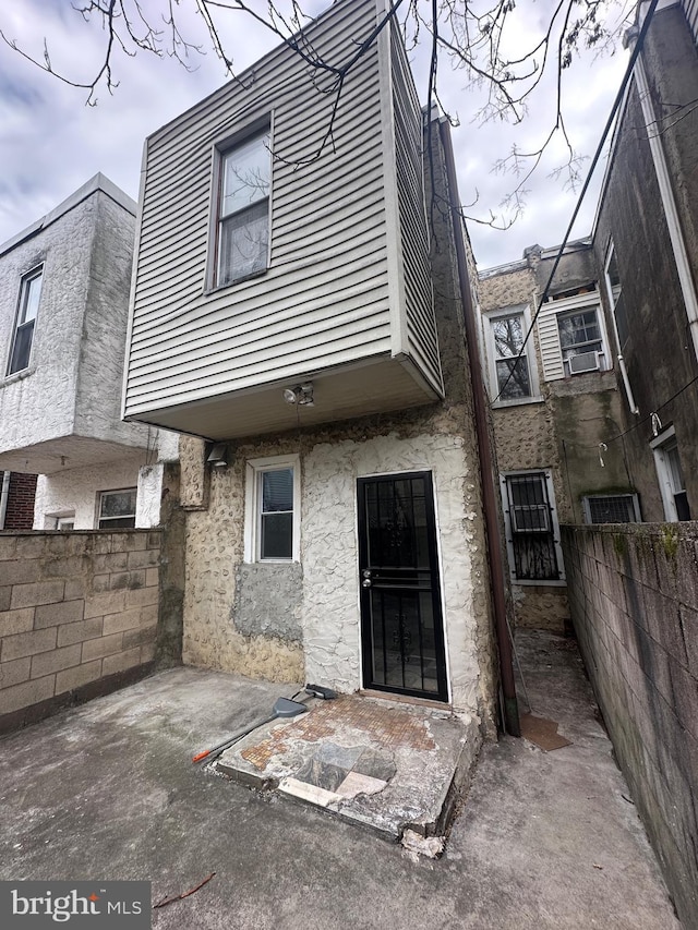 rear view of property featuring fence and a patio