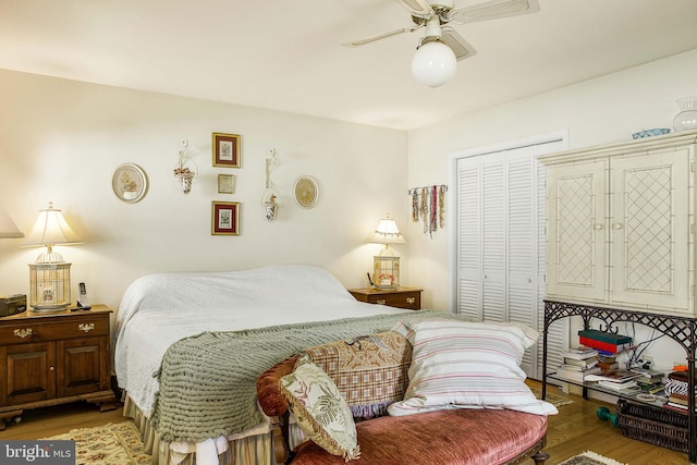 bedroom with a ceiling fan, a closet, and wood finished floors