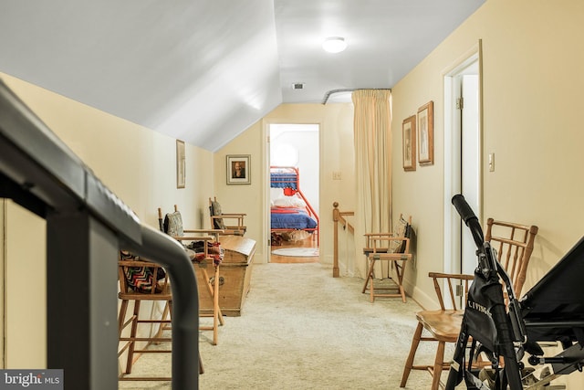 additional living space with carpet floors, visible vents, and lofted ceiling