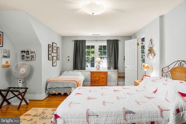 bedroom featuring baseboards and wood finished floors