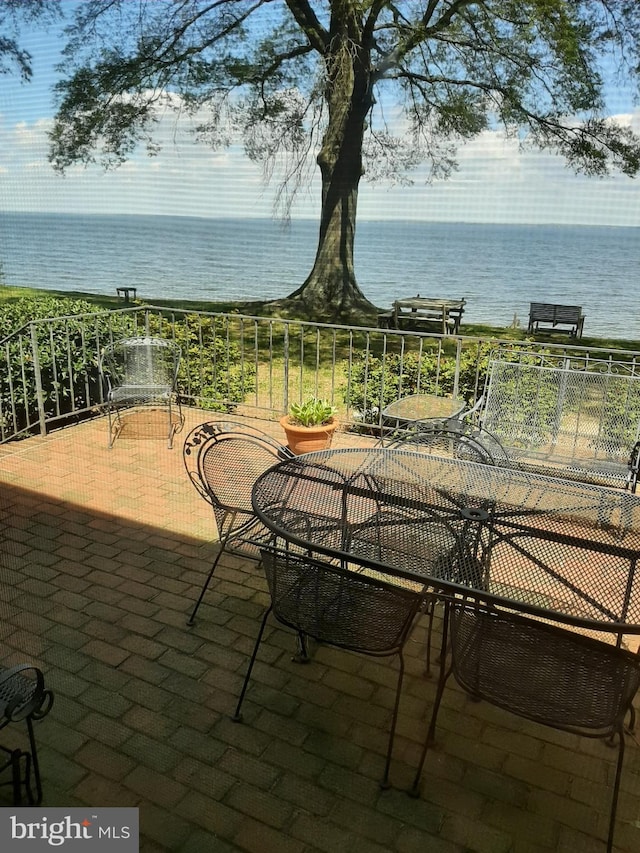 view of patio with a water view