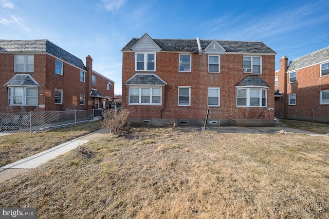 view of front of property with crawl space, fence, a front lawn, and brick siding