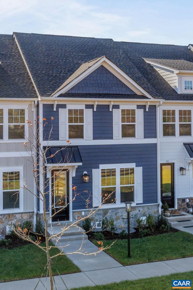 multi unit property with stone siding and roof with shingles