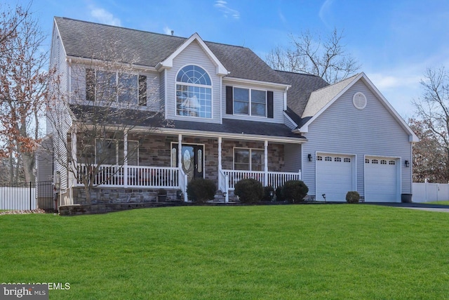 view of front of home with a porch, a garage, fence, stone siding, and a front lawn