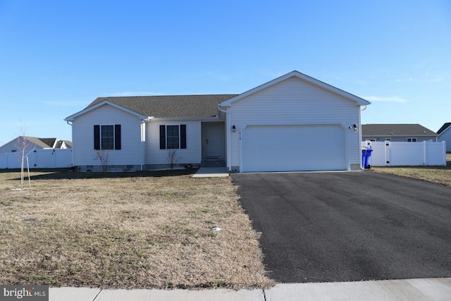 single story home with a garage, a front lawn, fence, and aphalt driveway