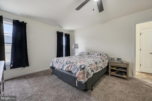 carpeted bedroom featuring a ceiling fan and baseboards