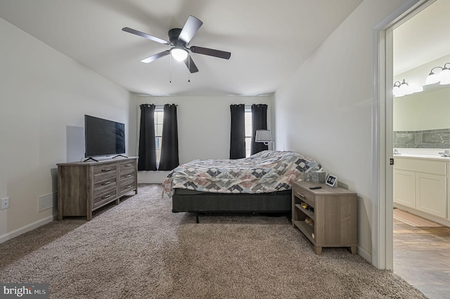 bedroom featuring ensuite bathroom, a ceiling fan, visible vents, baseboards, and carpet