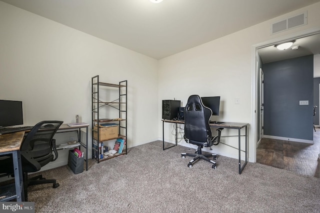 office space featuring carpet, visible vents, and baseboards