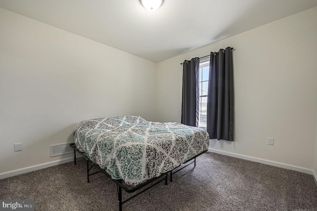 bedroom with carpet floors, baseboards, and visible vents