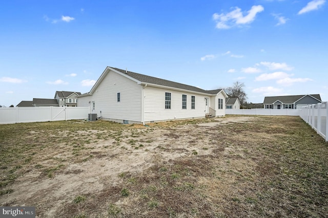 rear view of house featuring cooling unit, a fenced backyard, a lawn, and entry steps