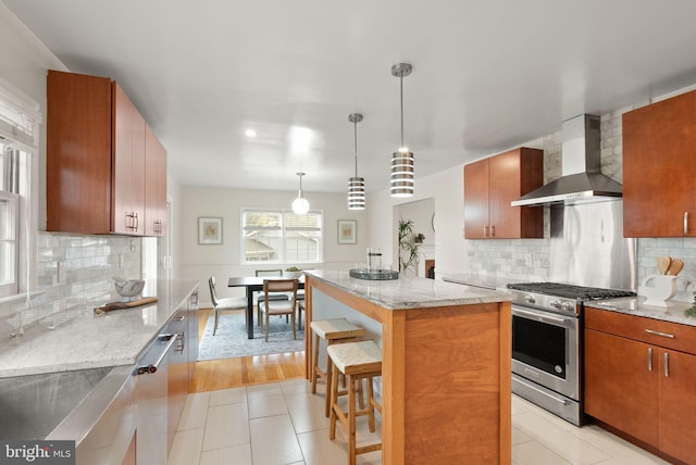 5924 Kimble Ct, Falls Church, VA 22041 - kitchen featuring wall chimney range hood, a breakfast bar, stainless steel appliances, backsplash, and light stone counters