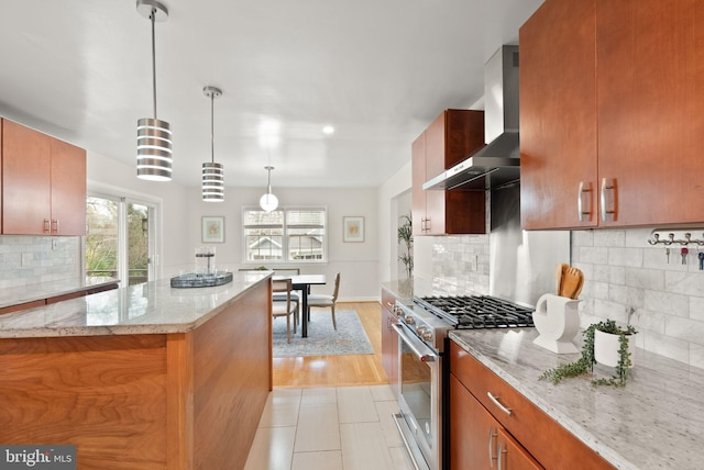 5924 Kimble Ct, Falls Church, VA 22041 - kitchen featuring pendant lighting, wall chimney range hood, light stone counters, high end stainless steel range oven, and backsplash