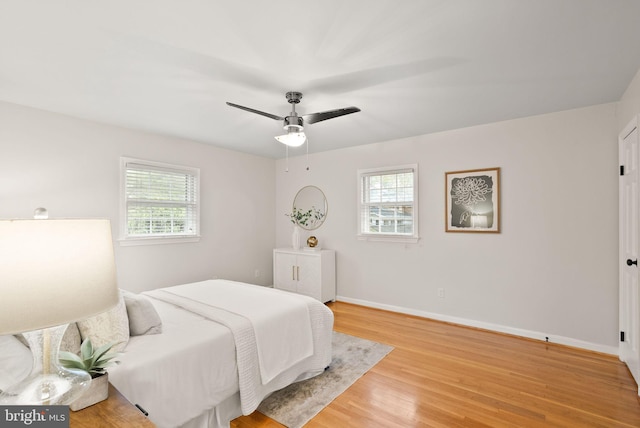 5924 Kimble Ct, Falls Church, VA 22041 - bedroom with light wood-type flooring, multiple windows, baseboards, and a ceiling fan
