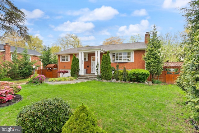 5924 Kimble Ct, Falls Church, VA 22041 - view of front of house featuring brick siding, a chimney, and a front lawn