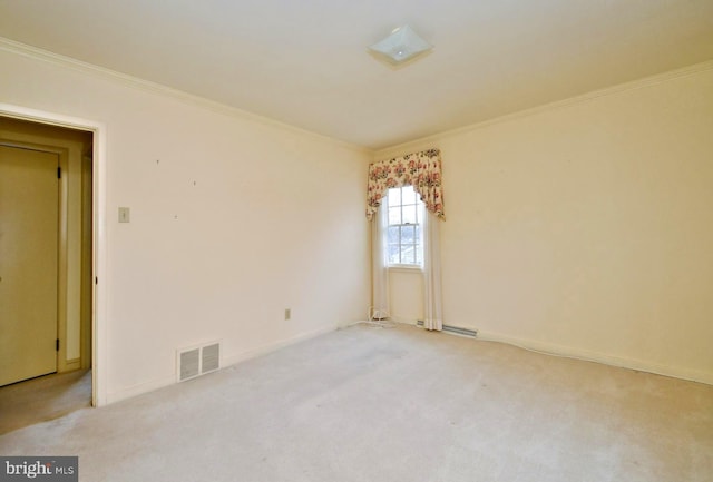 spare room featuring light carpet, baseboards, visible vents, and crown molding