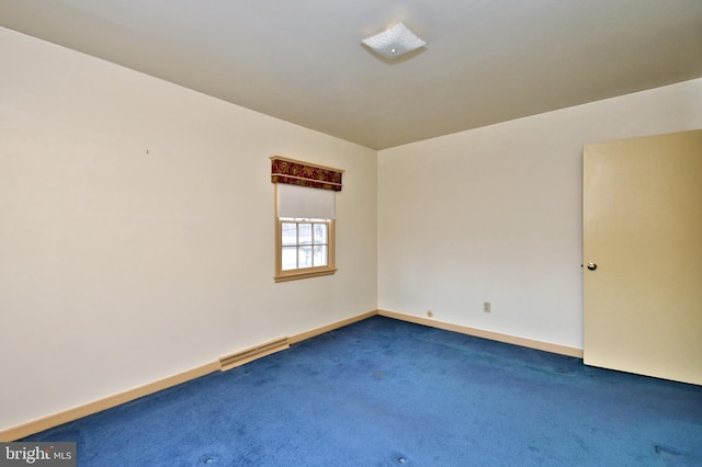 empty room with baseboards, visible vents, and carpet flooring