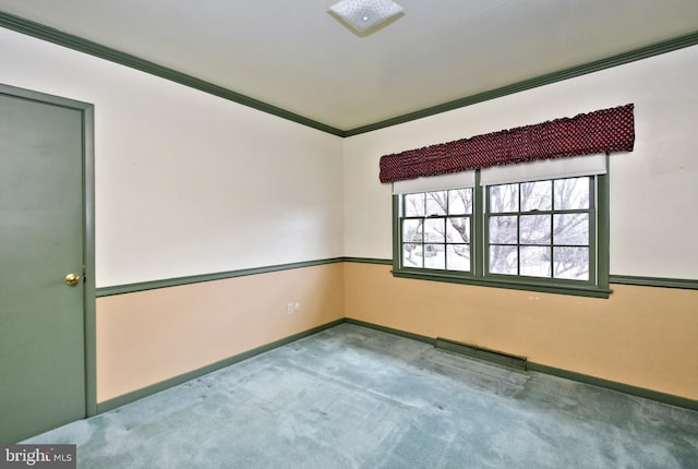 carpeted empty room with visible vents, crown molding, and baseboards