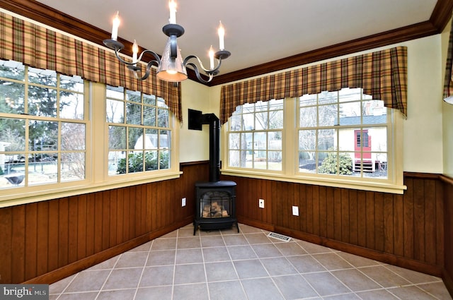 interior space featuring a wainscoted wall, a wealth of natural light, and crown molding