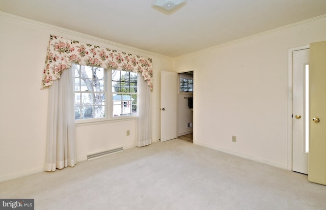 carpeted spare room featuring ornamental molding, a baseboard radiator, and baseboards