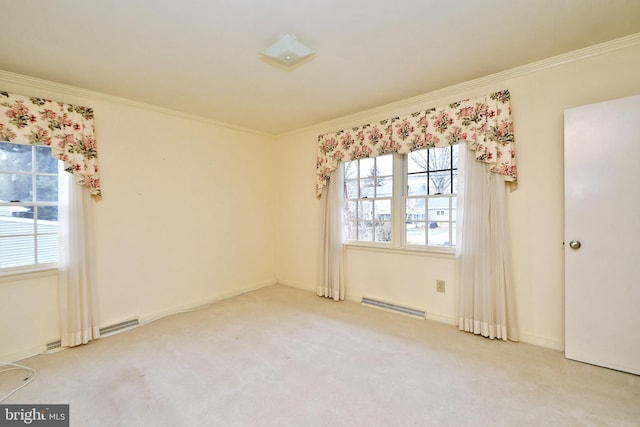 carpeted spare room featuring plenty of natural light, a baseboard radiator, visible vents, and ornamental molding