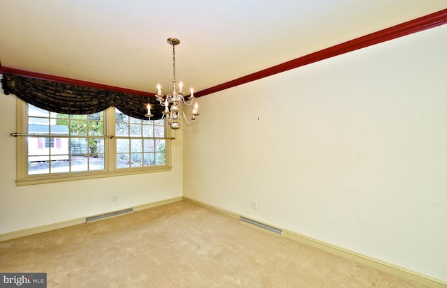 carpeted empty room with baseboards, visible vents, and a notable chandelier