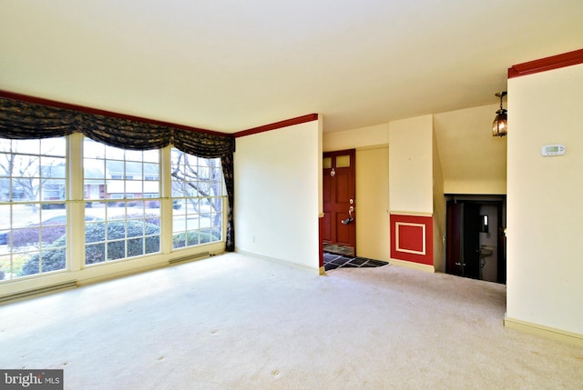 unfurnished living room with carpet floors and baseboards