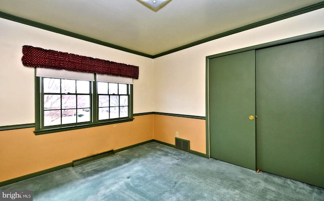 unfurnished bedroom with ornamental molding, carpet, a closet, and visible vents