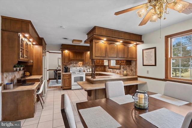 dining room with a ceiling fan and light tile patterned flooring