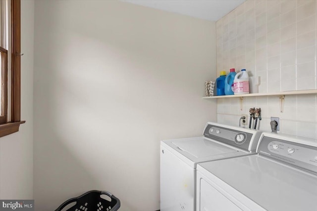 washroom with washer and dryer and laundry area