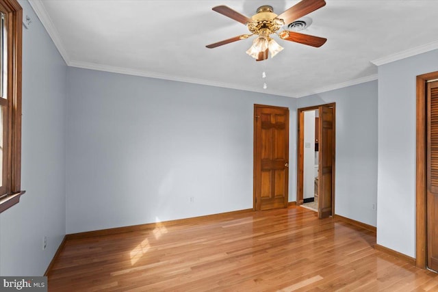 unfurnished bedroom with crown molding, a closet, light wood-style flooring, and baseboards