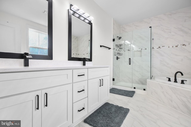 full bath with marble finish floor, a garden tub, double vanity, a stall shower, and a sink