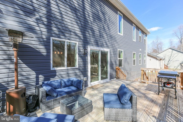 wooden terrace with grilling area and an outdoor hangout area