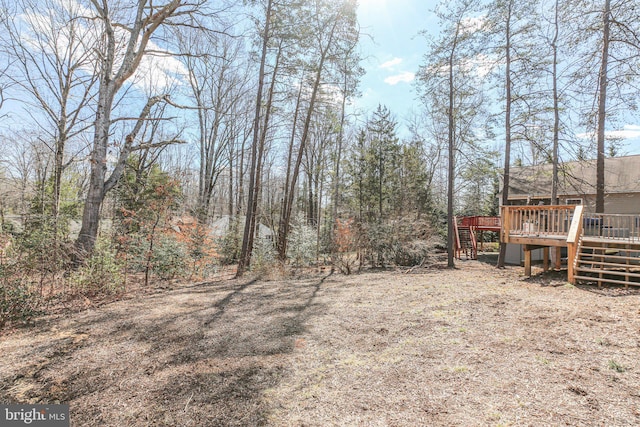 view of yard with a deck and stairway