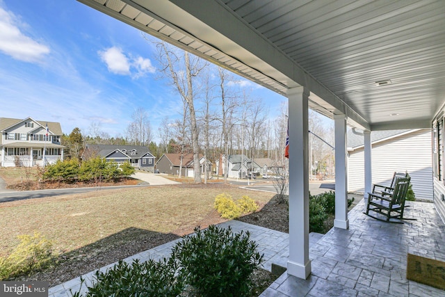 view of patio / terrace with a porch and a residential view