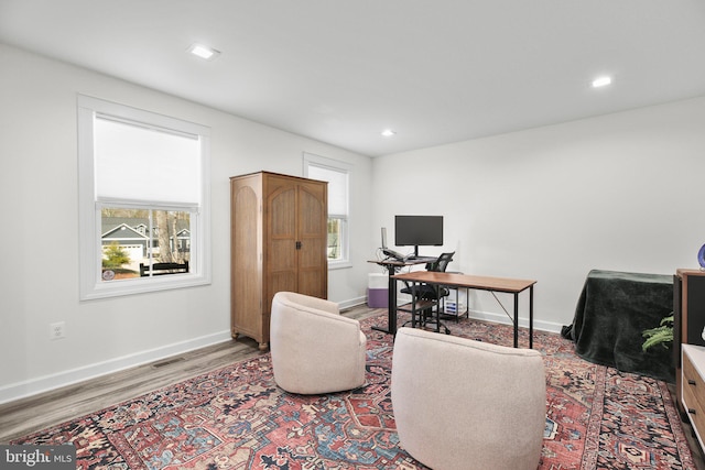 home office featuring a wealth of natural light, recessed lighting, baseboards, and wood finished floors