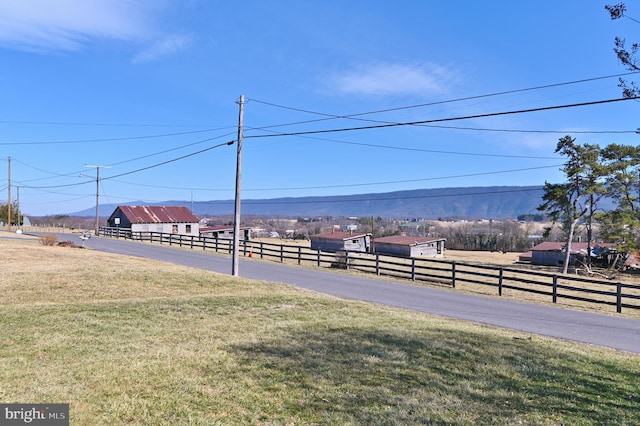 view of yard with a rural view and fence